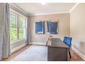 Stylish office with a large window, desk, and comfortable blue chair at 2675 Sugar Mill Dr, Atlanta, GA 30316