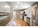 Well-lit kitchen with stainless steel appliances, granite countertops, and white cabinetry at 4076 Blanton Sw Ave, Atlanta, GA 30331