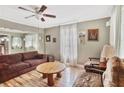 Bright living room featuring hardwood floors, a ceiling fan, and classic charm at 4076 Blanton Sw Ave, Atlanta, GA 30331