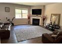 Comfortable living room features a fireplace, large window, and plush gray rug at 3604 Sw Wartrace Sw Dr, Atlanta, GA 30331