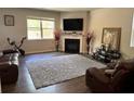 Relaxing living room space with a fireplace, a large window and lots of comfortable seating at 3604 Sw Wartrace Sw Dr, Atlanta, GA 30331