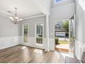 Bright dining room featuring new flooring, wainscoting, and a modern chandelier at 507 Mirramont Pl, Woodstock, GA 30189