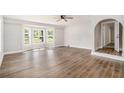 Bright living room boasts new floors, a ceiling fan, and a large bay window at 1132 Luther Sw Dr, Mableton, GA 30126