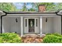 Inviting front entrance featuring a decorative door with sidelights and classic white columns at 3150 Rilman Nw Rd, Atlanta, GA 30327