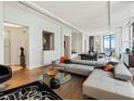 Open-concept living space featuring hardwood floors, a large sectional sofa, and seamless flow to the dining area at 3376 Peachtree Ne Rd # 44B, Atlanta, GA 30326