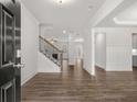 Inviting entryway with hardwood floors, showcasing an open floor plan leading to the staircase and the living room at 76 Parkview Dr, Dallas, GA 30157