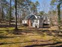 Side view of the house with a garage and plenty of backyard trees at 1480 Niskey Lake Sw Rd, Atlanta, GA 30331