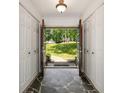 Light-filled foyer with slate flooring, double closets, and an open view to the lush greenery outside at 239 Devonwood Dr, Atlanta, GA 30328