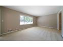 Bright living room featuring large windows and neutral carpeting at 2921 Huntcliff Dr, Marietta, GA 30066
