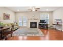 Inviting living room features a fireplace, hardwood floors, and a walk-out to the deck at 3229 Hallmark Ln, Buford, GA 30519
