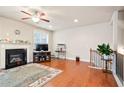 Bright living room boasts a cozy fireplace, hardwood floors, and a staircase at 3229 Hallmark Ln, Buford, GA 30519