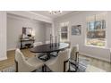 Bright dining room features an oval table, six chairs, natural light from two large windows, and modern decor at 4549 Ajo Lot#30 Walk, Atlanta, GA 30331