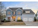 Beautiful two-story home featuring a well-maintained lawn, two-car garage, and inviting front entrance with lighting at 520 Tackett Farms Rd, Smyrna, GA 30082