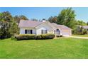 View of a well-maintained home featuring a lush lawn, and manicured landscaping at 265 Mountainview Dr, Covington, GA 30016