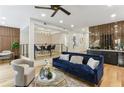 Open-concept living room with a modern dining area, stylish bar area, and beautiful hardwood flooring at 1906 Variations Ne Dr, Atlanta, GA 30329