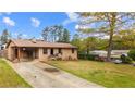 Inviting brick home featuring a well-manicured front lawn, driveway, and covered front porch at 338 Patricia Sw Ave, Marietta, GA 30060