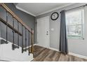 Stylish entryway with wood-look floors, natural light, and staircase at 135 N North River Dr, Atlanta, GA 30350