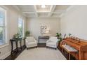 Inviting living room featuring coffered ceilings, hardwood floors, and neutral walls for a calming atmosphere at 3065 Arbor Song Ct, Cumming, GA 30041