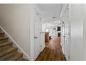 Hallway with hardwood floors that lead to a staircase and living area, creating a seamless flow at 5570 Stonewood Ct, Norcross, GA 30093