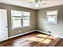 Cozy bedroom with ample natural light from two windows and sleek wood flooring at 1277 4Th Ave, Auburn, GA 30011