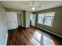 Spacious bedroom featuring closet, wood floors, a ceiling fan, and ample natural light at 1277 4Th Ave, Auburn, GA 30011