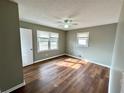 Bedroom featuring wood floors, neutral walls, and ample natural light from two large windows at 1277 4Th Ave, Auburn, GA 30011