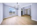 Airy dining room with hardwood floors, chandelier, and a large window offering views at 175 Paislee Park (Lot # 11 Paislee Park) Dr, Fayetteville, GA 30215