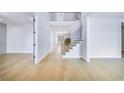 Spacious foyer with gleaming hardwood floors, leading to a staircase and other rooms at 175 Paislee Park (Lot # 11 Paislee Park) Dr, Fayetteville, GA 30215