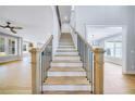 Elegant staircase with wood treads, black iron railings, and a light-filled foyer at 175 Paislee Park (Lot # 11 Paislee Park) Dr, Fayetteville, GA 30215