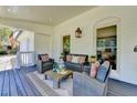 A charming covered patio is adorned with comfortable seating and stylish decor at 5567 Stapleton Dr, Dunwoody, GA 30338