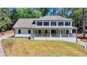 Charming two-story home with a white brick facade, blue shutters, and a welcoming front porch at 5567 Stapleton Dr, Dunwoody, GA 30338