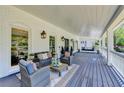 Spacious covered porch with comfortable seating and a swing for leisurely enjoyment at 5567 Stapleton Dr, Dunwoody, GA 30338