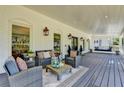 Inviting porch featuring outdoor seating, decorative lanterns, and a swing at 5567 Stapleton Dr, Dunwoody, GA 30338