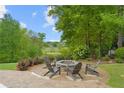Cozy backyard firepit area with comfortable seating and a lush green landscape at 177 Grandmar Chase, Canton, GA 30115