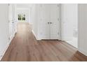 Bright hallway showcasing hardwood floors, closet space, and natural light from a window at 1216 Cedarcrest Blvd, Acworth, GA 30101