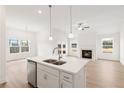 Kitchen and living area featuring an island, stainless steel appliances, fireplace, and ample natural light at 1216 Cedarcrest Blvd, Acworth, GA 30101