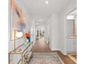 Bright entryway with hardwood floors, stylish decor, and view into the home's open-concept layout at 1220 Cedarcrest Blvd, Acworth, GA 30101