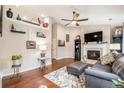 Spacious living room with hardwood floors, fireplace, neutral paint, ample shelving, and large windows that let in natural light at 624 Spanish Oak Dr, Acworth, GA 30102