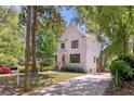 Inviting two-story home with white siding, dark trim, and a long driveway at 842 Bridgewater Sw St, Atlanta, GA 30310