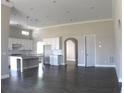 Open concept living space with hardwood floors, a kitchen view, and arched doorway at 2925 Coach River Way, Cumming, GA 30040