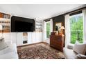Cozy living room features built-in shelving, large windows, and hardwood floors at 297 Breeze Hill Ln, Canton, GA 30114