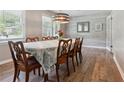 Elegant dining room with wood floors, decorative chandelier, and charming wall details at 3925 Chicamauga Ne Dr, Kennesaw, GA 30144