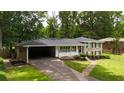Lovely two-story house featuring an attached carport and manicured landscaping at 3925 Chicamauga Ne Dr, Kennesaw, GA 30144