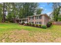 Beautiful brick home with lush front yard landscaping and inviting entrance, showcasing its charm at 3925 Chicamauga Ne Dr, Kennesaw, GA 30144