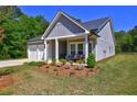 Charming single-Gathering home with a two-car garage, covered porch, and colorful landscaping at 1014 Starmoss Ln, Conyers, GA 30094