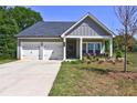 Charming single-Gathering home with a two-car garage, covered porch, and well-manicured lawn at 1014 Starmoss Ln, Conyers, GA 30094