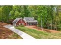 Beautiful brick home with an attached garage, long drive, and a well-manicured lawn at 125 Abner Dr, Mcdonough, GA 30252