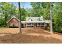 Attractive brick home featuring a cozy front porch in a serene, wooded setting at 125 Abner Dr, Mcdonough, GA 30252