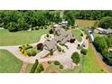 A sprawling estate with lush lawns, mature trees and landscaping, and lake access at 2220 Peachtree Rd, Cumming, GA 30041