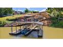 Two story dock featuring a gazebo, plenty of seating, and water access for boating and swimming at 2220 Peachtree Rd, Cumming, GA 30041